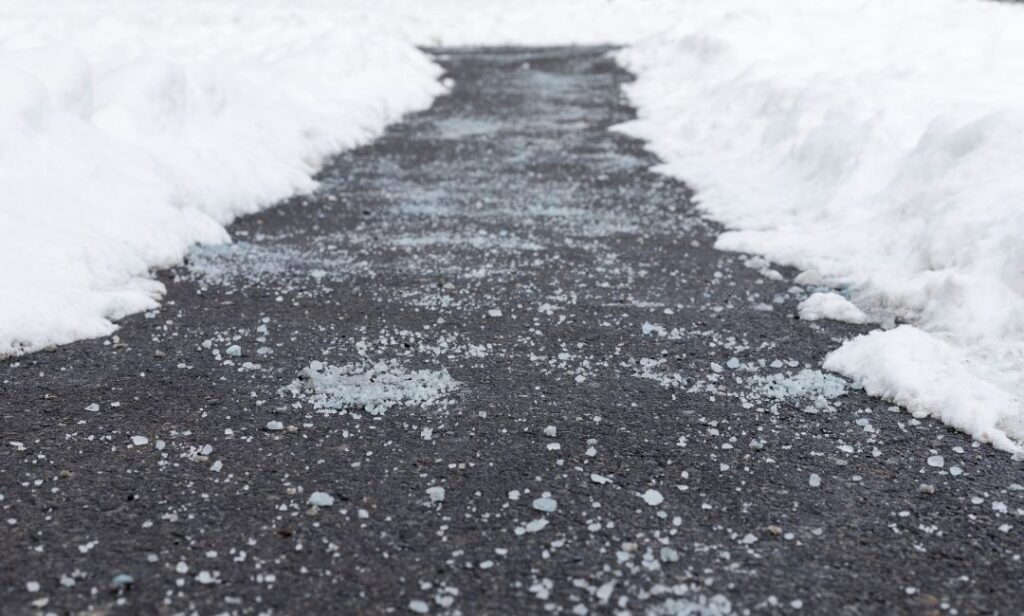 Salt sidewalks and driveways after shoveling and scraping 